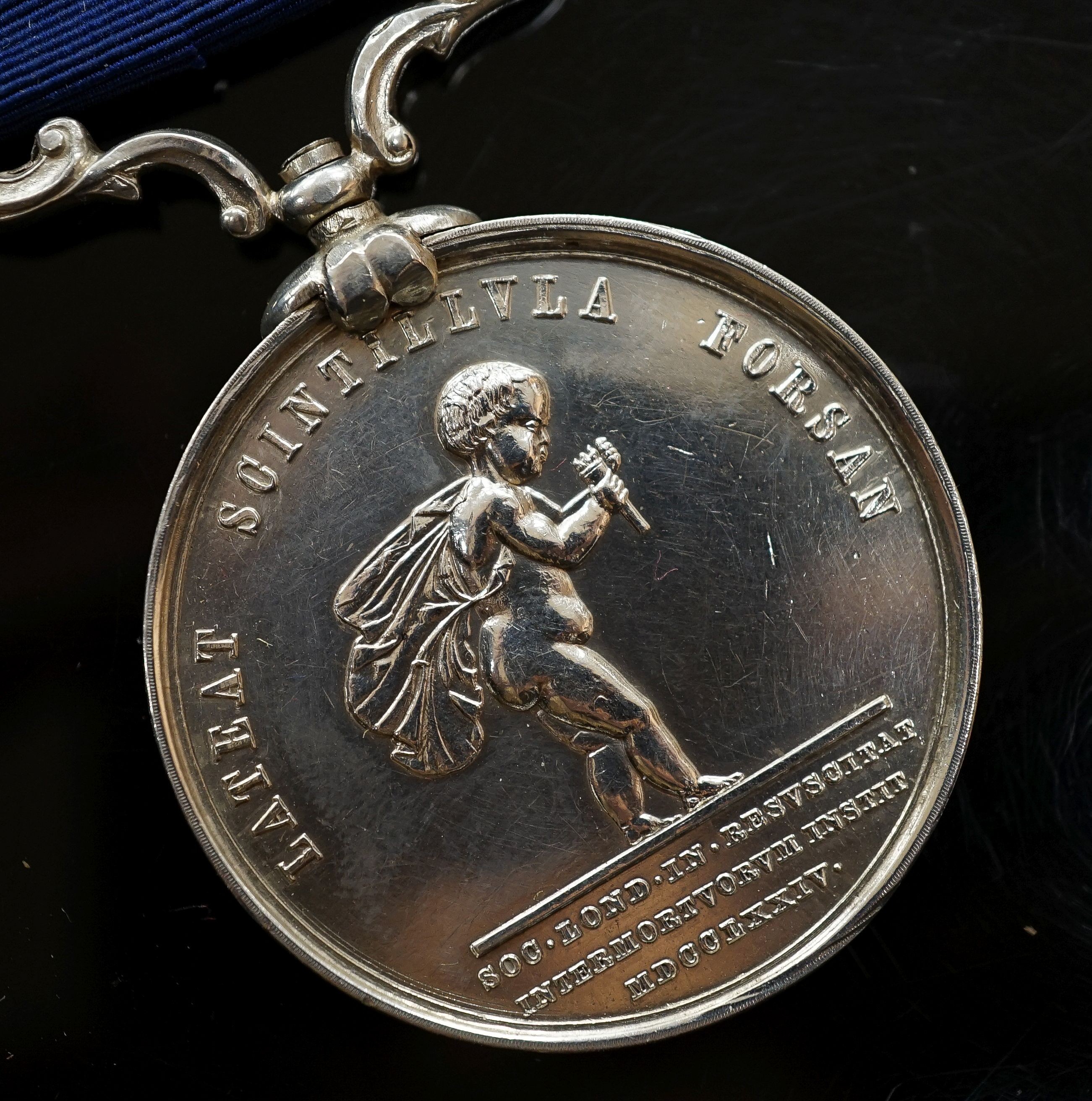 A Royal Humane Society small silver medal, the clasp initialled R.T.M.